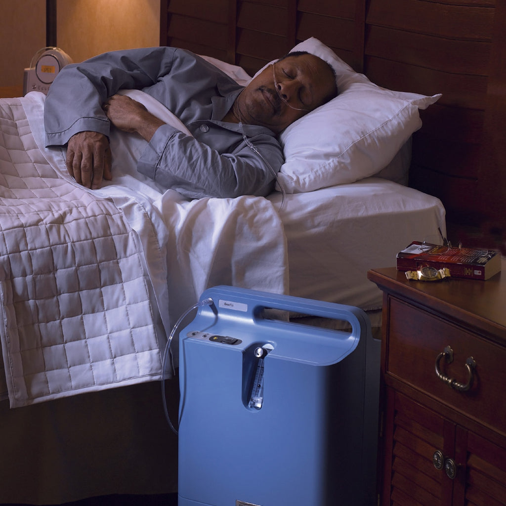 Man Sleeping next to an Everflo Oxygen Concentrator 