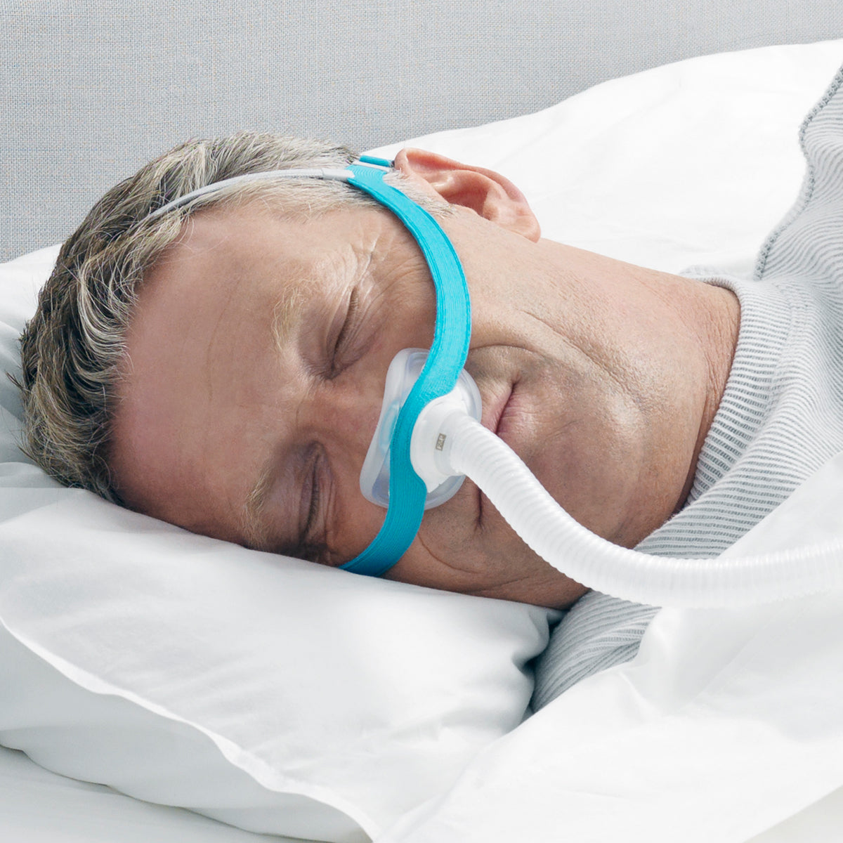 Man Sleeping with an Evora Nasal CPAP mask 
