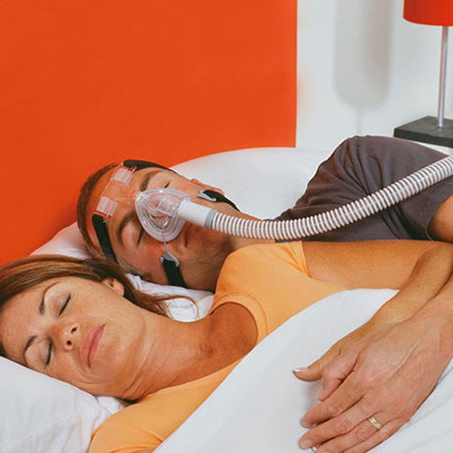 Man Sleeping in Bed wearing a FlexiFit 407 CPAP Mask 