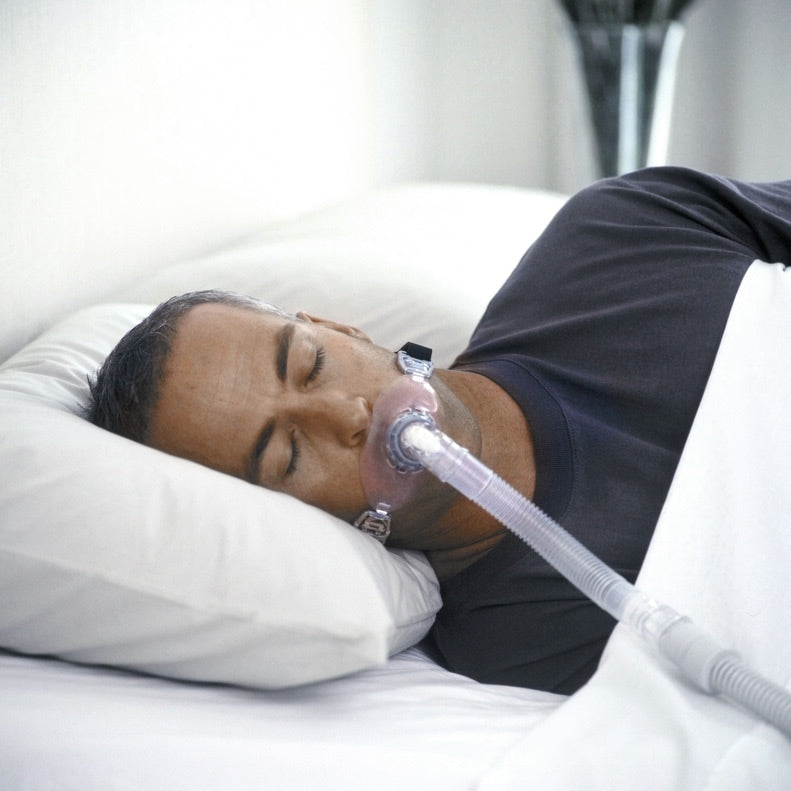 Man in Bed Using an Oracle CPAP Mask 