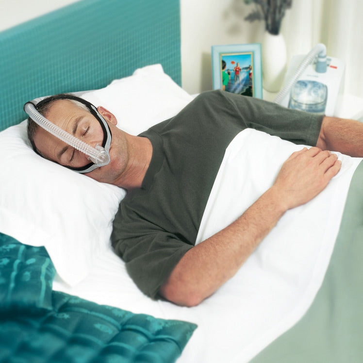 Man sleeping on his side while wearing an Opus 360 CPAP Mask