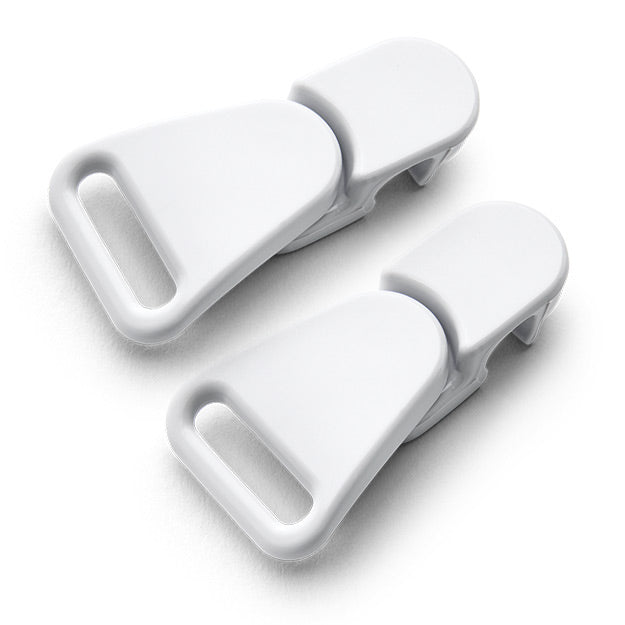 Two white plastic clips on a light gray background