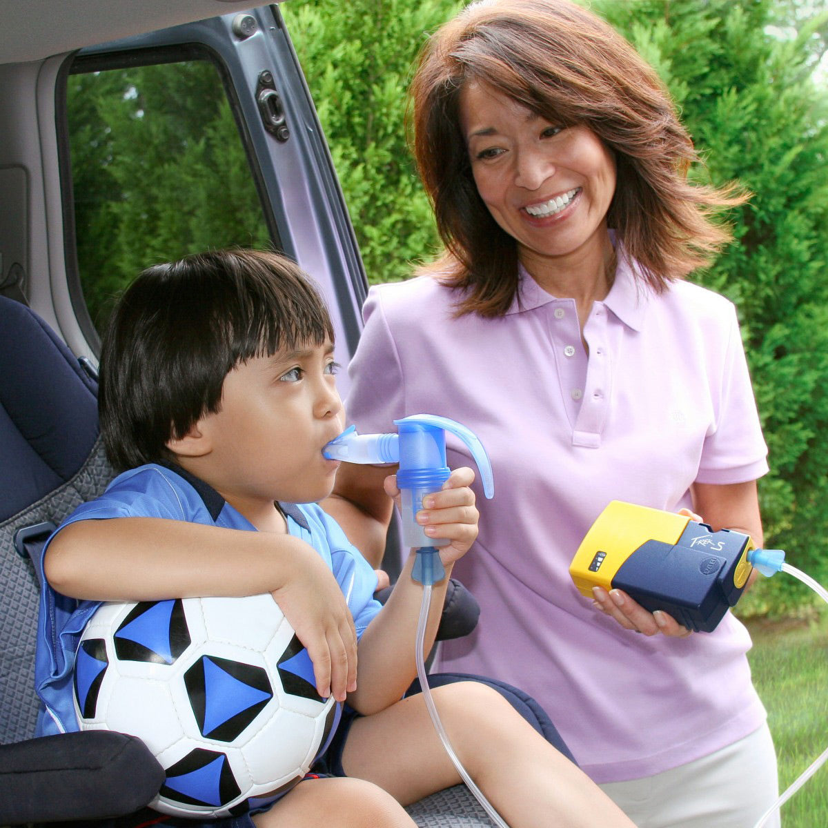 A child Using a Pari Trek S Portable Nebulizer Compressor 
