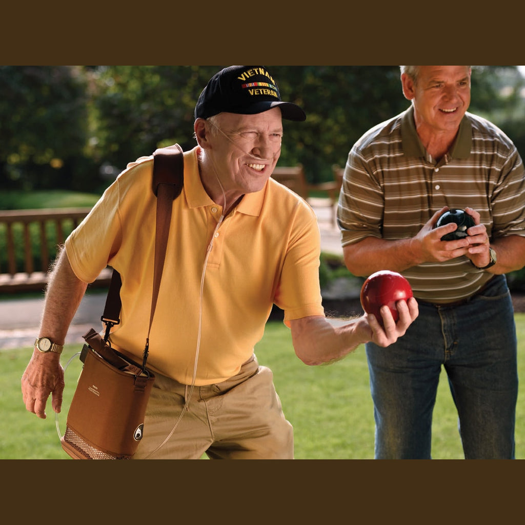 Man using a SimplyGo Mini Concentrator while doing an outdoor sport 