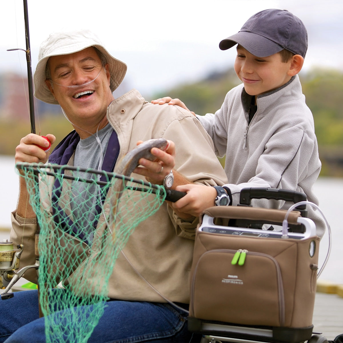 Man Fishing with child while wearing a SimplyGo Oxygen Concentrator 