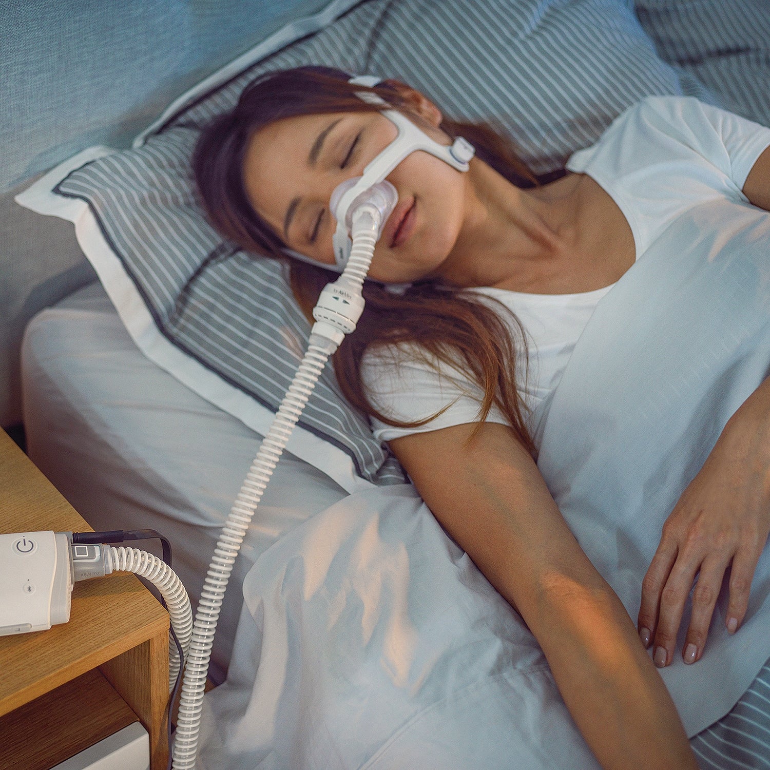 Woman In Bed wearing AirMini AirFit N20 Mask 