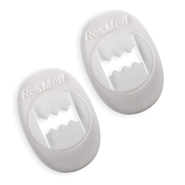 Two white headgear clips with the ResMed logo.