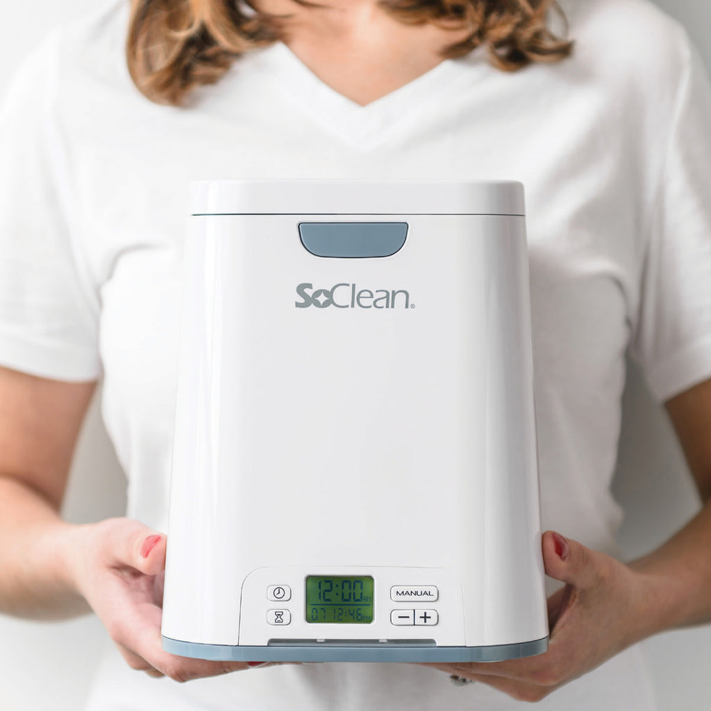 Woman Holding a SoClean CPAP Sanitizer Machine 